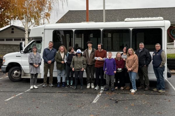 Brave Warrior NCW participants stand with Link Transit staff in front of a van awarded to them from the Surplus Van Grant program.